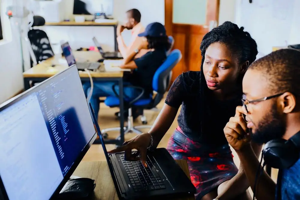 2 people working together on a computer