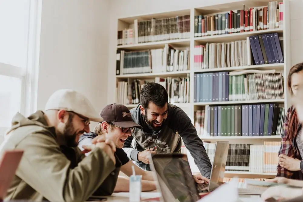 employees having fun at work and wording together